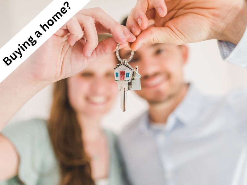 A couple with keys to a home they just purchased after having a buying home inspection pre purchase building inspection